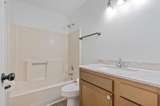 bathroom featuring toilet, vanity, and shower / bath combination
