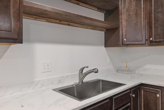 kitchen featuring a sink, dark brown cabinets, and light countertops