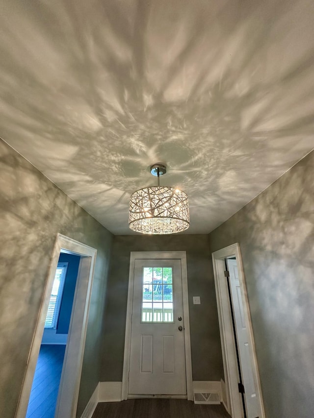 entryway with baseboards and dark wood-style flooring