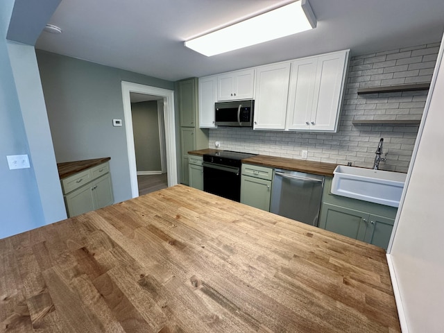 kitchen with open shelves, a sink, wood counters, appliances with stainless steel finishes, and backsplash