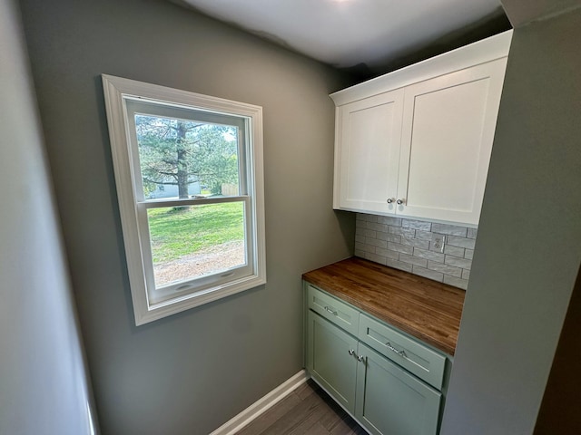 interior space with baseboards and dark wood-type flooring