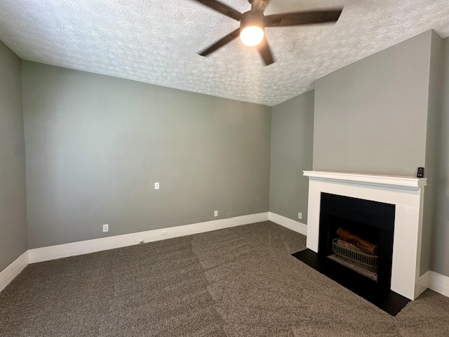 unfurnished living room with carpet floors, a textured ceiling, ceiling fan, and baseboards