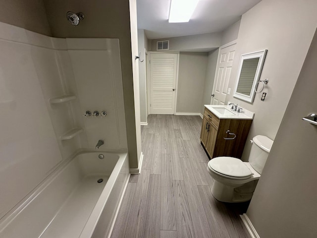 bathroom with visible vents, wood finished floors, baseboards, vanity, and toilet