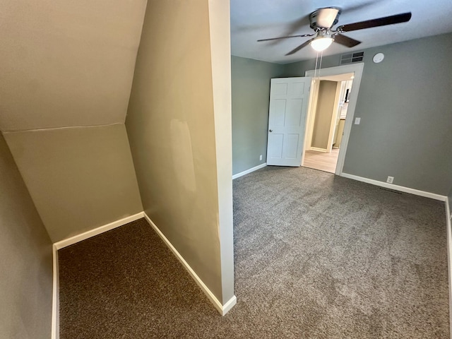 empty room featuring ceiling fan, visible vents, baseboards, and carpet