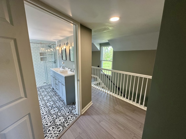 hallway featuring recessed lighting and lofted ceiling