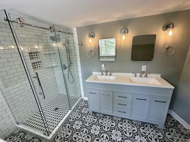 bathroom with a sink, tile patterned floors, a stall shower, and double vanity