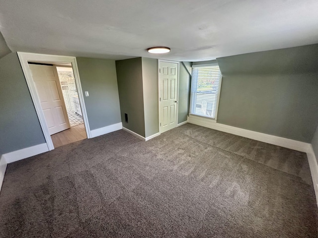bonus room with baseboards and carpet flooring