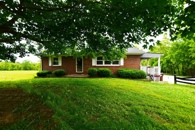 215 Stacy Lane Rd, Irvine, KY 40336 - view of front of house featuring a front yard, brick siding, and a carport