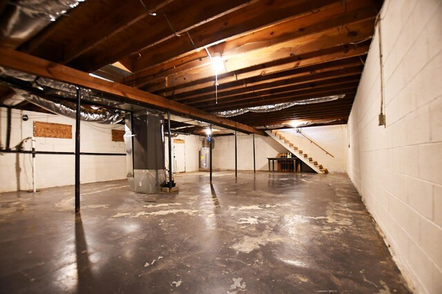 215 Stacy Lane Rd, Irvine, KY 40336 - unfinished basement featuring water heater, stairway, concrete block wall, and heating unit