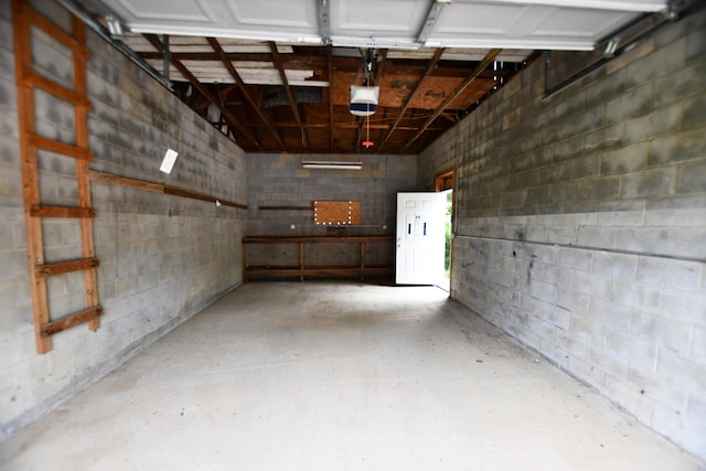 215 Stacy Lane Rd, Irvine, KY 40336 - garage with concrete block wall and a garage door opener