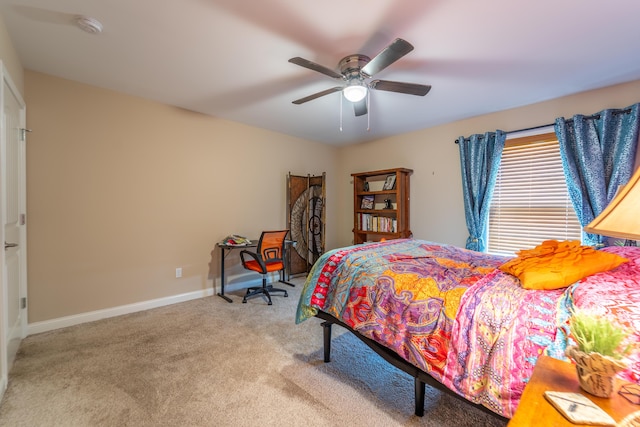 carpeted bedroom featuring a ceiling fan and baseboards