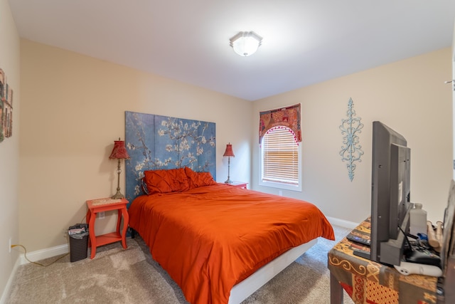 bedroom featuring baseboards and carpet flooring
