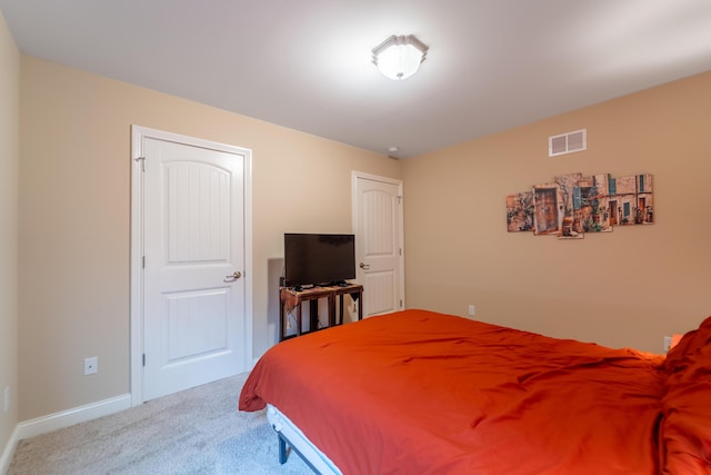 carpeted bedroom with baseboards and visible vents
