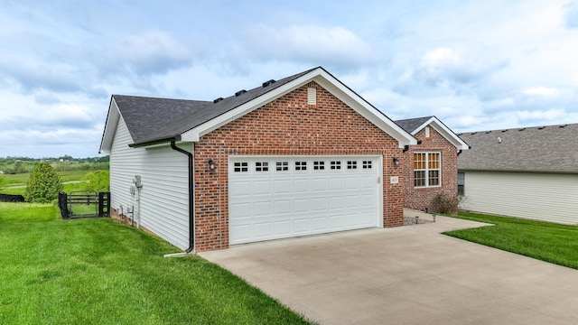 view of side of home with driveway, brick siding, a yard, an attached garage, and a shingled roof