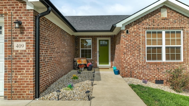 entrance to property with brick siding, roof with shingles, and crawl space
