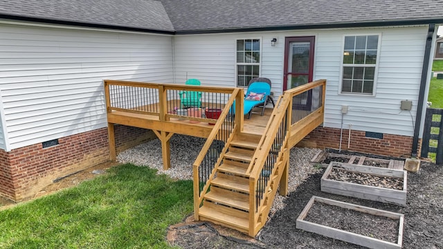 deck with stairs and a garden