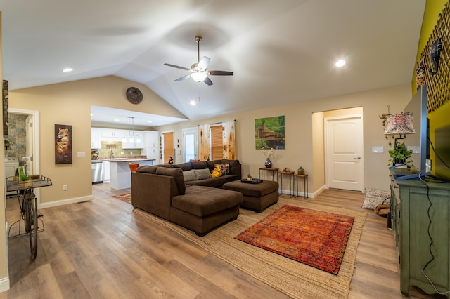 living room with ceiling fan, light wood-style floors, recessed lighting, baseboards, and vaulted ceiling