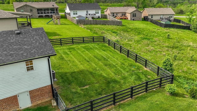 view of yard with cooling unit, a residential view, and a fenced backyard