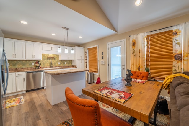 dining space with recessed lighting, vaulted ceiling, and light wood-style flooring