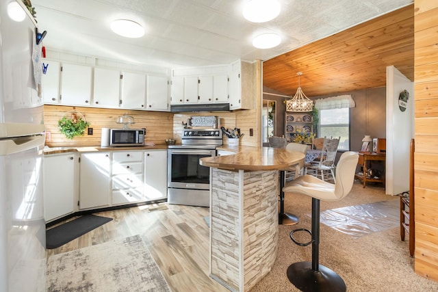 2805 W W Ridge Rd, Eubank, KY 42567 - kitchen featuring light wood-type flooring, white cabinetry, appliances with stainless steel finishes, and an inviting chandelier