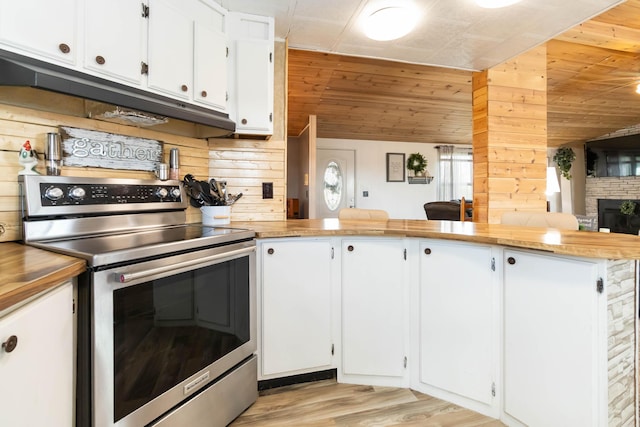 2805 W W Ridge Rd, Eubank, KY 42567 - kitchen featuring wood walls, stainless steel range with electric stovetop, light wood-type flooring, white cabinetry, and under cabinet range hood