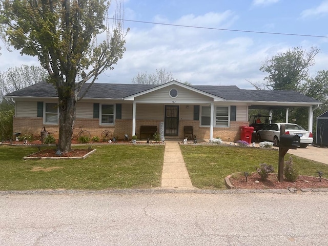 single story home featuring a front yard, a porch, and brick siding