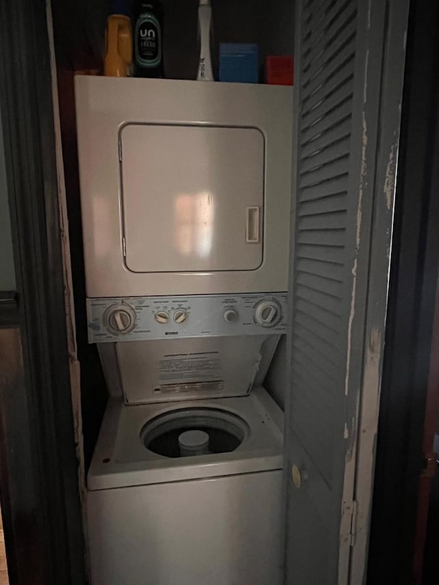 laundry room featuring stacked washer and dryer and laundry area