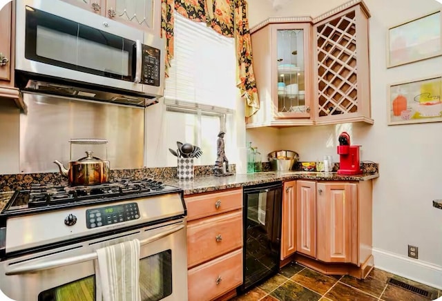 kitchen with stainless steel appliances, baseboards, stone counters, wine cooler, and glass insert cabinets