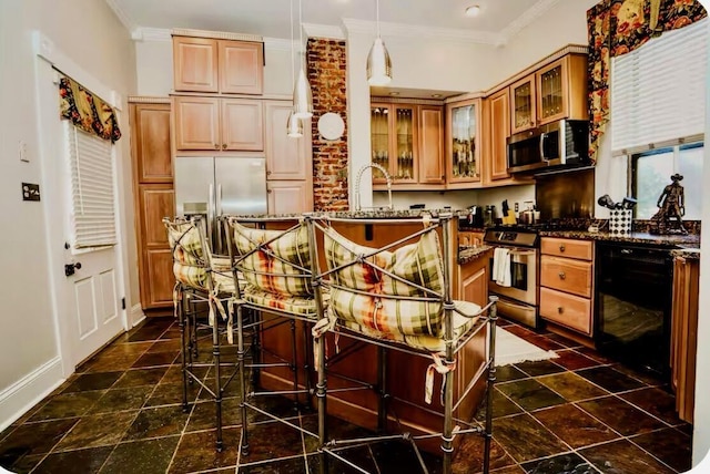 kitchen featuring ornamental molding, glass insert cabinets, baseboards, a center island, and appliances with stainless steel finishes