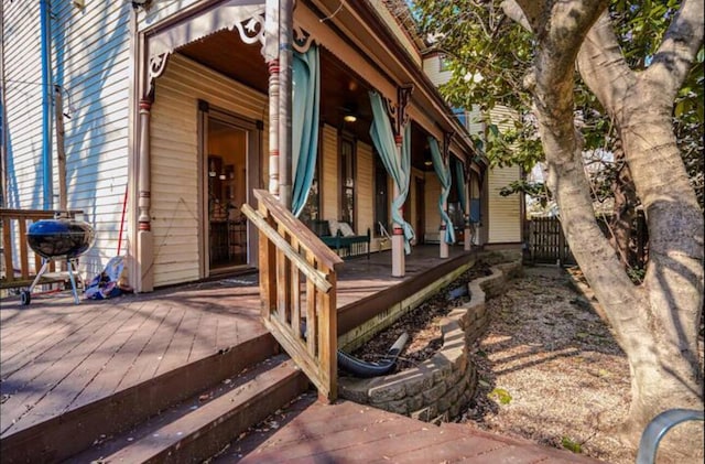 view of home's exterior featuring covered porch and a wooden deck