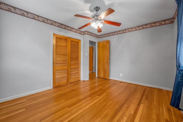 unfurnished bedroom with baseboards, a ceiling fan, a closet, and light wood-style flooring