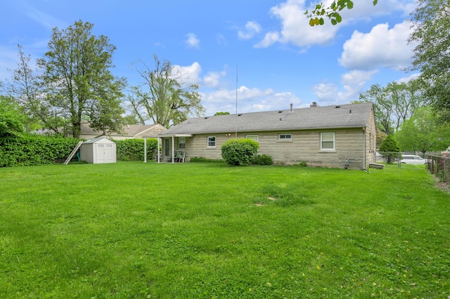 view of yard featuring fence, an outdoor structure, and a shed