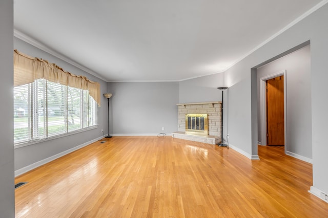 unfurnished living room featuring crown molding, visible vents, wood finished floors, and a fireplace