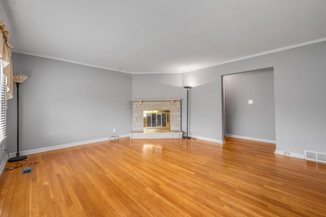 unfurnished living room featuring visible vents, crown molding, and wood finished floors