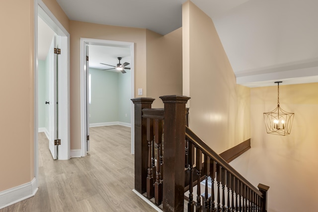 262 Main St, Salt Lick, KY 40371 - hallway featuring an upstairs landing, a chandelier, light wood-style floors, and baseboards