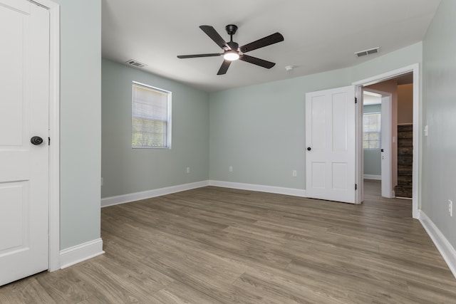 262 Main St, Salt Lick, KY 40371 - unfurnished bedroom with multiple windows, wood finished floors, baseboards, and ceiling fan