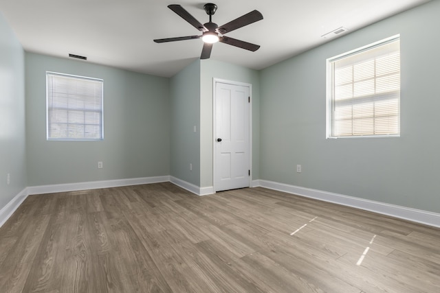 262 Main St, Salt Lick, KY 40371 - unfurnished bedroom featuring wood finished floors, multiple windows, and baseboards
