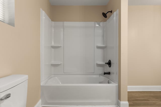 262 Main St, Salt Lick, KY 40371 - bathroom with tub / shower combination, toilet, baseboards, and wood finished floors