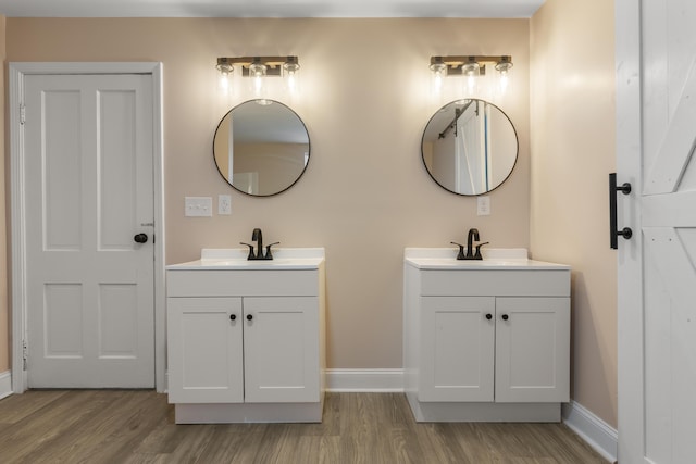262 Main St, Salt Lick, KY 40371 - bathroom featuring wood finished floors, two vanities, and baseboards