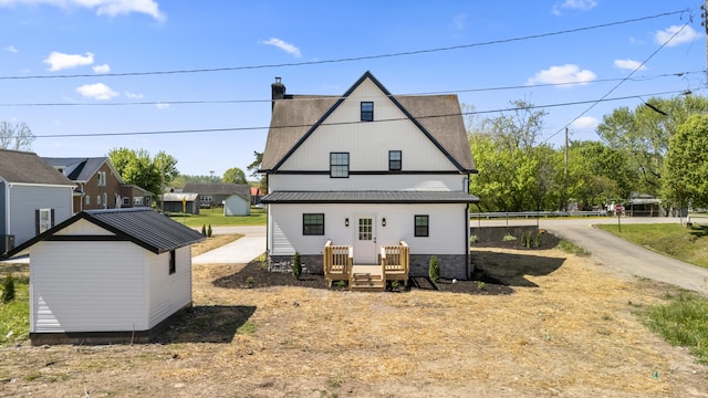 262 Main St, Salt Lick, KY 40371 - rear view of house with an outdoor structure, a chimney, and metal roof