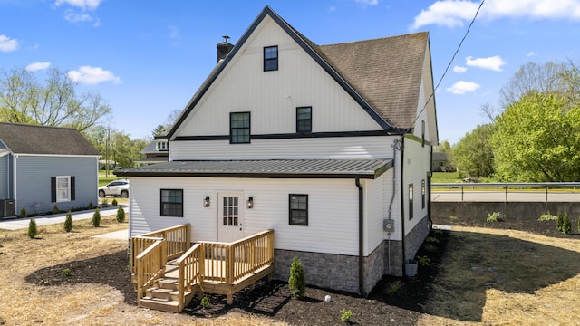 262 Main St, Salt Lick, KY 40371 - back of property with a chimney, metal roof, a wooden deck, central AC unit, and roof with shingles