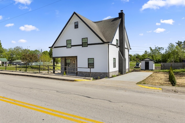 262 Main St, Salt Lick, KY 40371 - modern farmhouse style home with a chimney, concrete driveway, stone siding, and a shingled roof