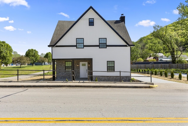 262 Main St, Salt Lick, KY 40371 - view of front of property with stone siding, a chimney, a shingled roof, and a porch