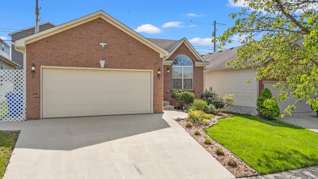 view of front of home featuring brick siding, a garage, a front lawn, and driveway