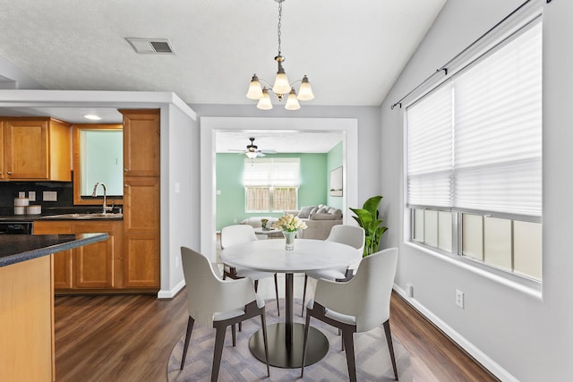 dining room with baseboards, dark wood finished floors, and visible vents