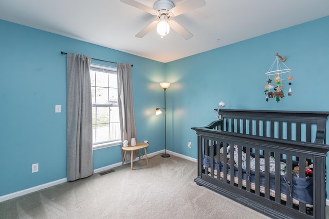 bedroom featuring visible vents, baseboards, carpet floors, and a nursery area