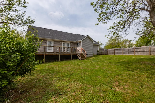 back of house featuring french doors, a lawn, a deck, a fenced backyard, and stairs