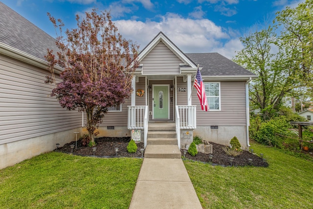 view of front facade featuring a shingled roof, a front lawn, and crawl space
