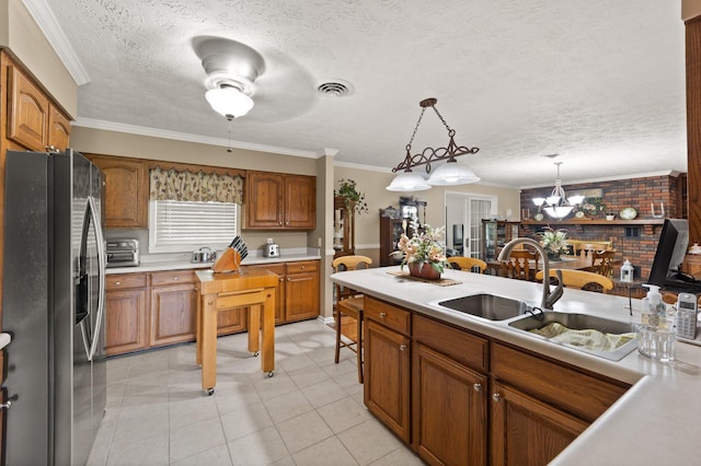 223 Lanetown Rd, Nancy, KY 42544 - kitchen with brown cabinets, stainless steel fridge, a sink, ceiling fan with notable chandelier, and a toaster