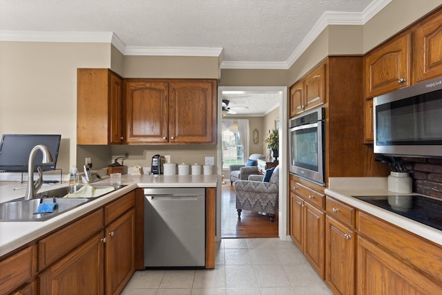 223 Lanetown Rd, Nancy, KY 42544 - kitchen with light countertops, a sink, brown cabinetry, and stainless steel appliances